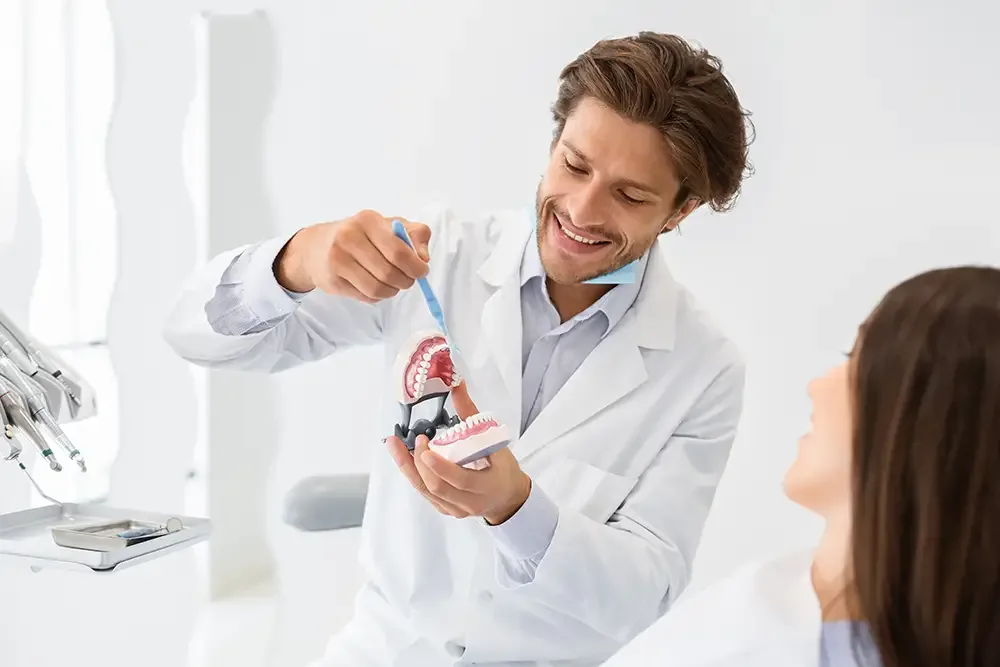Dentist demonstrating proper brushing technique