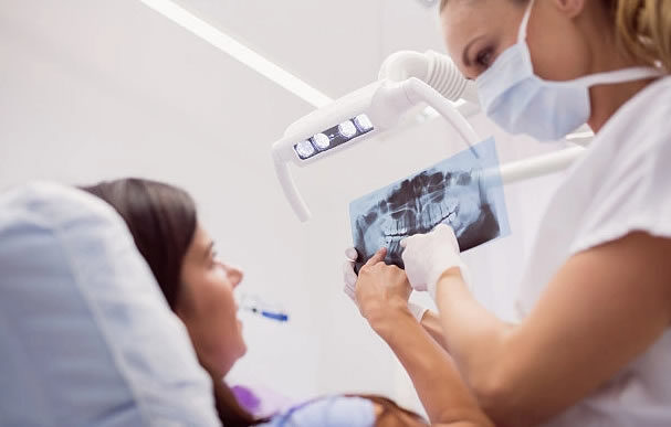Dentist showing X-ray results to patient