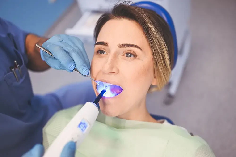 Patient receiving dental filling with UV light