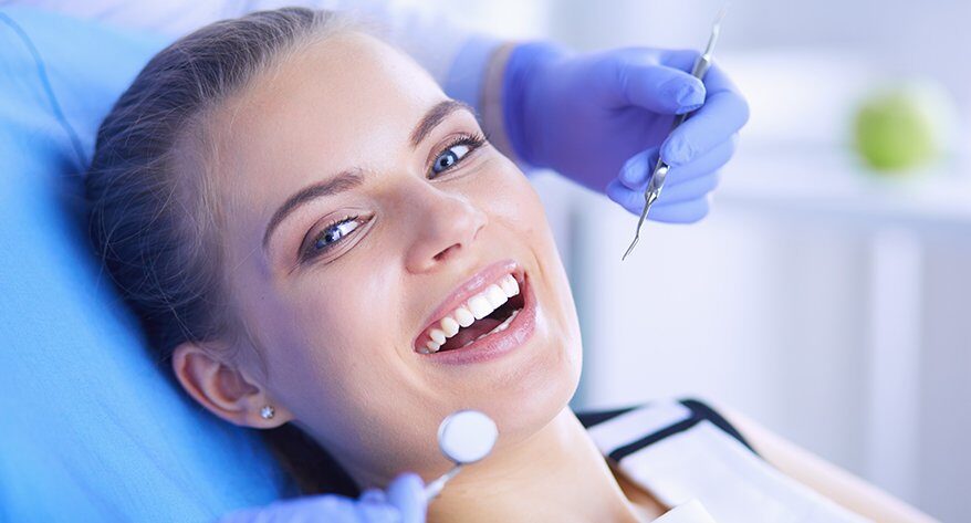 Dentist checking patient smile after sealant treatment